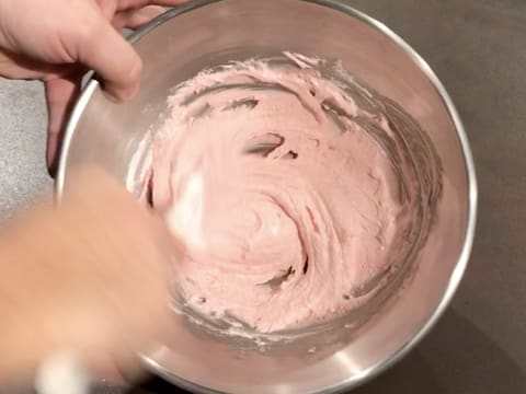 Mélange de la préparation à macarons rose, à l'aide de la spatule