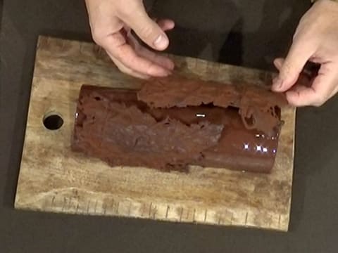 Un second décor en chocolat est déposé sur la bûche