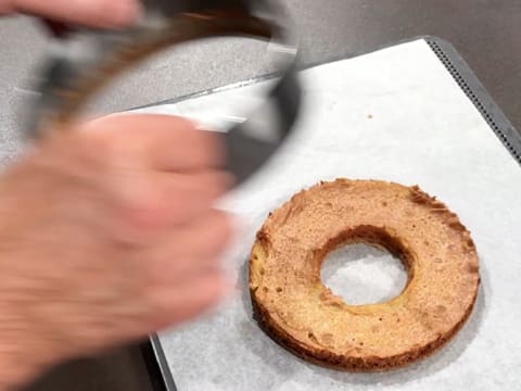 Le cercle à mousse est retiré de l'anneau de biscuit streusel noisette et de biscuit miel/tonka