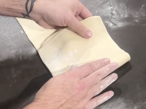 Le côté droit de la pâte est rabattu sur un premier tiers de la pâte