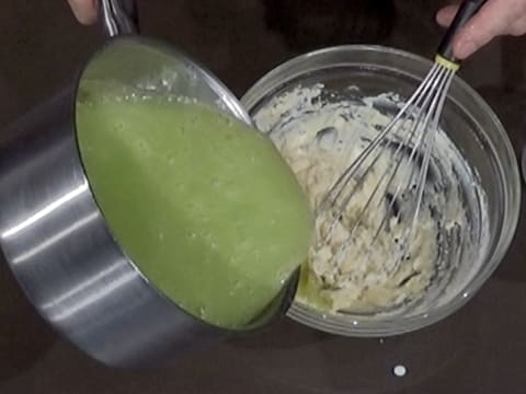 La préparation crémeuse verte est versée sur la pâte faite de poudre de lait et d'eau