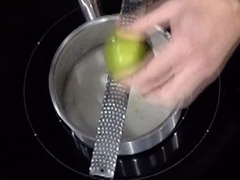Ajout des zestes de citron vert dans la casserole, sur le jus de citron vert et le sucre en poudre