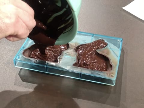 Chocolat fondu versé dans moule lapin