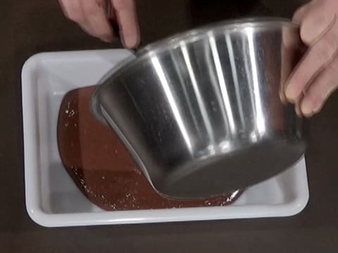 Le crémeux au chocolat est débarrassé dans un bac alimentaire