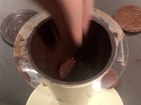 Un disque de biscuit chocolat est déposé sur le confit de griotte