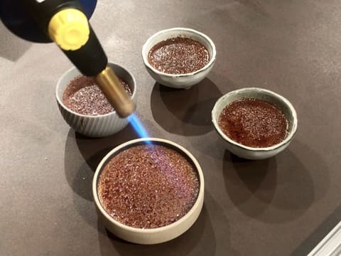 Caramelization of all chocolate creme brulees with a kitchen blow torch