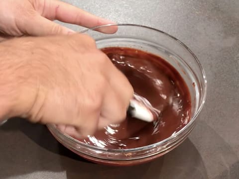 Stir the chocolate ganache with a rubber spatula