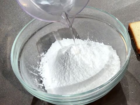 Place water and icing sugar in a bowl