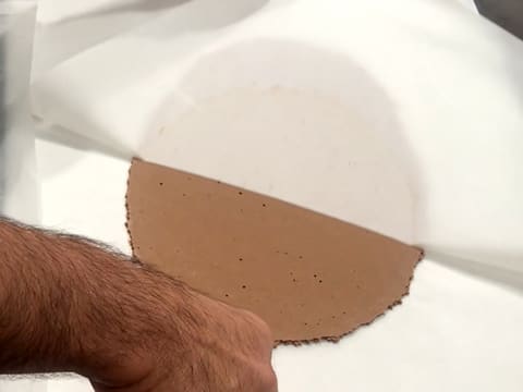 Remove the baking parchment from the crunchy coconut biscuit