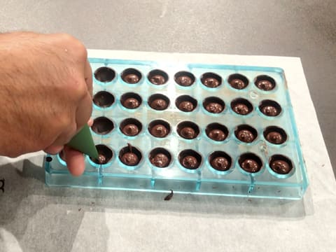 Pipe the coconut ganache into the chocolate shells