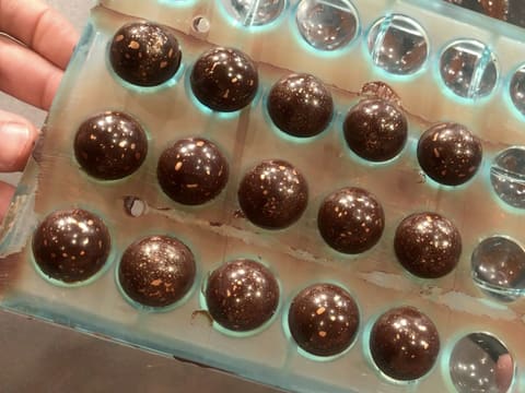 The Christmas coconut chocolates are assembled in the mould cavities