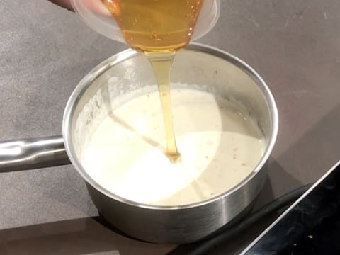 Add honey to the cream in the saucepan