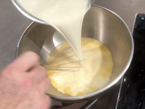 Pour the hot cream over the blanched preparation and whisk