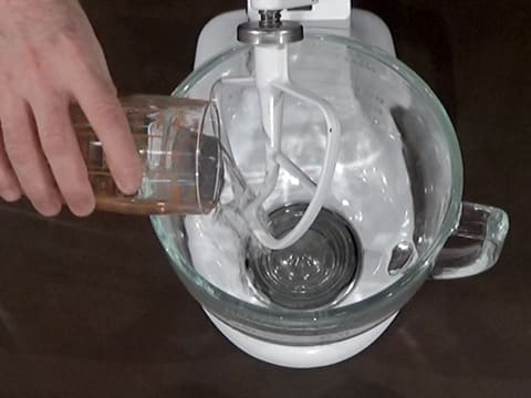 Pour water in stand mixer bowl fitted with flat beater