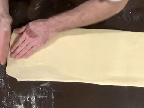 Place the dough horizontally on kitchen workbench