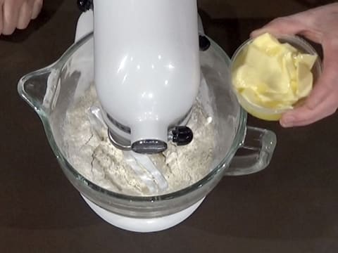 Softened butter is shown next to stand mixer bowl