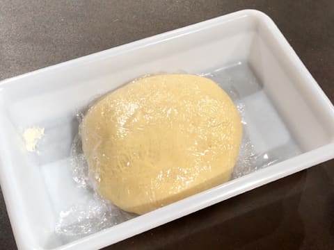 Cover the surface of the brioche dough ball with cling film