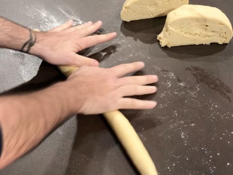 Roll the brioche dough with your hands on a floured surface