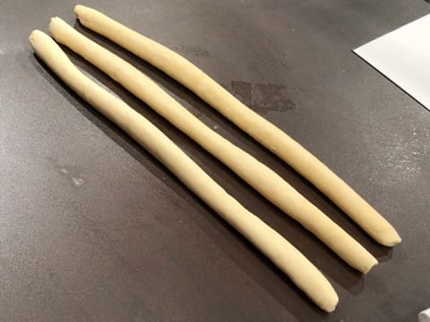 Three long strands of brioche dough