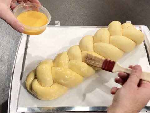 Glaze the surface of the brioche with egg wash and a pastry brush