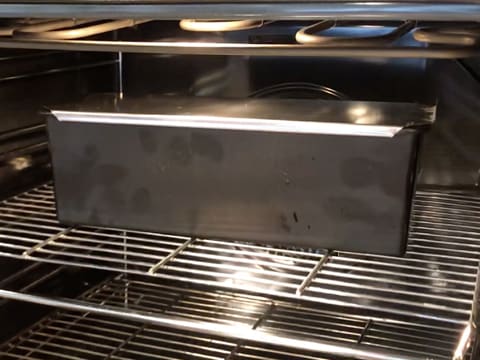 The bread pan is on the middle rack in the oven