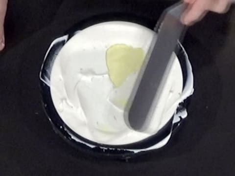 La mousse est lissée à la surface, avec une spatule métallique coudée