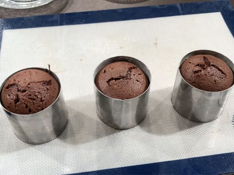 Obtention de trois mi-cuits au chocolat sur le tapis de cuisson en silicone, le tout posé sur le plan de travail