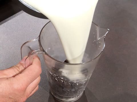 Pour the milk preparation over the chocolate in a pouring jug