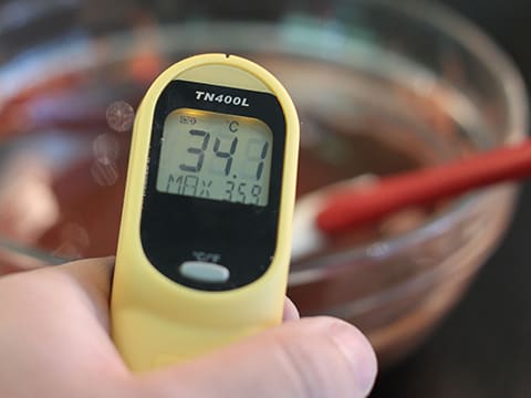 Measuring the temperature of chocolate in a bowl. Special infrared