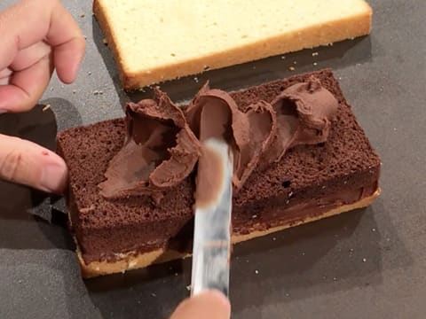 Spread chocolate ganache over the cake