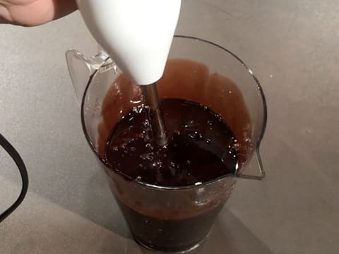 Mix the chocolate icing inside the jug with a hand blender