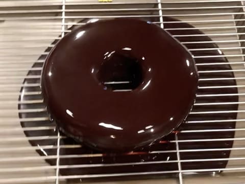 The chocolate icing drips down through the rack into the food tray