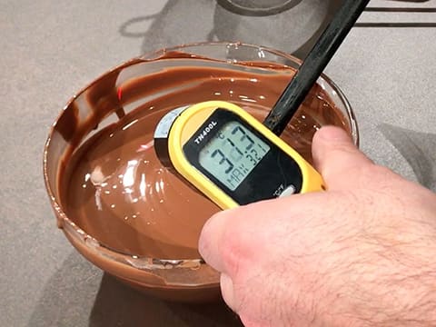 Measuring the temperature of chocolate in a bowl. Special infrared