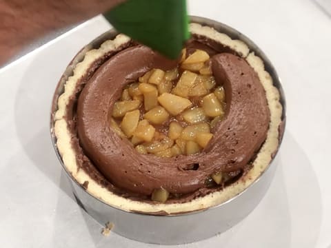 The chocolate mousse is piped over the pears