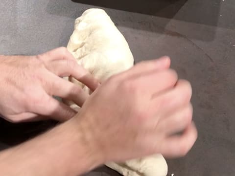 The dough is folded on the workbench